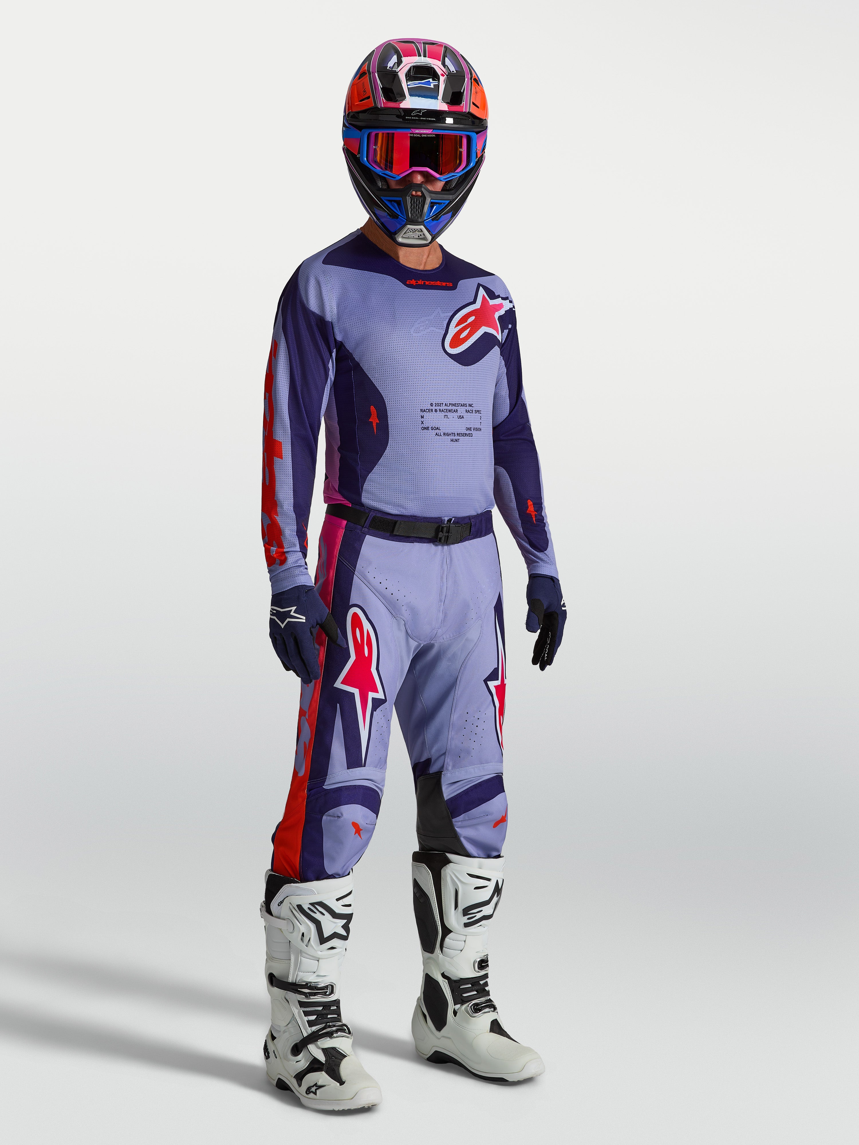 Alpinestars Racer Air Hunt jersey, geventileerde motocross jersey voor heren in paars en roze mesh, op model met volledige MX-uitrusting.