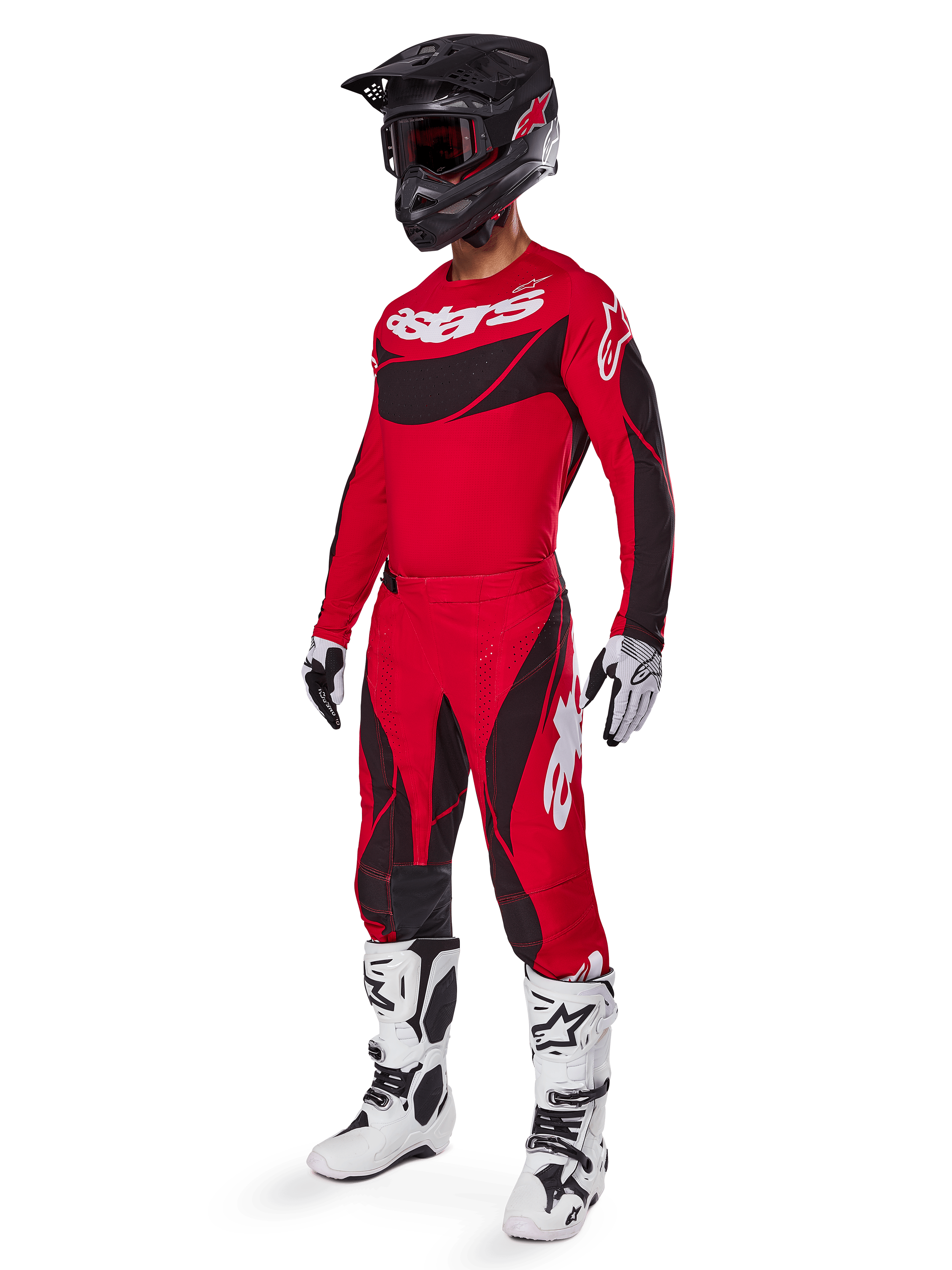 Ganzkörperansicht eines Motocross-Fahrers im 2025 Techstar Dreem Gear Set in Hellrot und Schwarz, mit einem Performance-Trikot mit weißem Branding, passender Stretch-Ripstop-Hose, einem schwarzen Helm mit rotem Visier, weiß-schwarzen Handschuhen und weißen Tech-Stiefeln, spezialisierte Rennausrüstung für Offroad-Wettbewerbe.