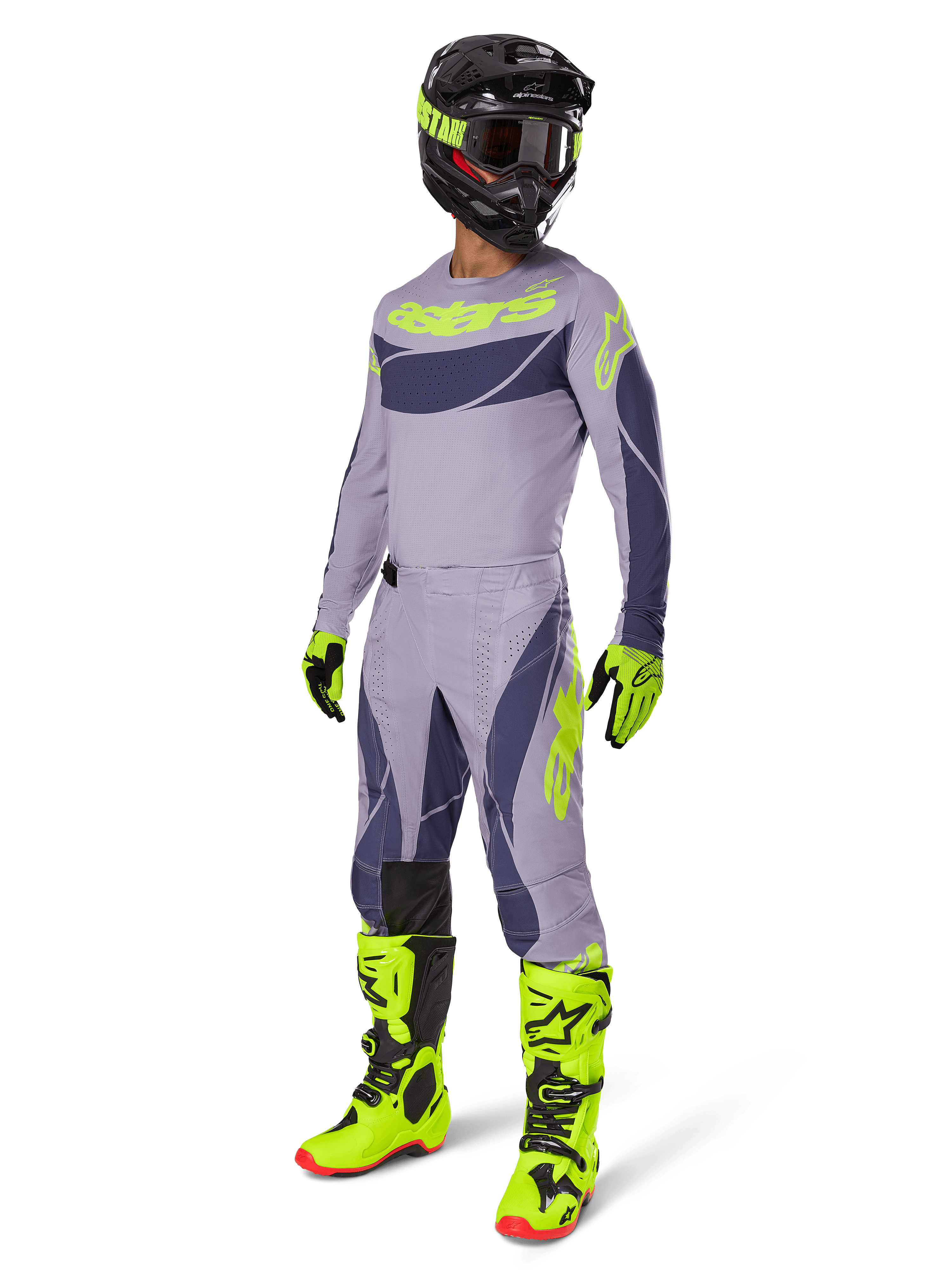 Alpinestars 2025 Techstar Dreem Gear Set, Motocross-Fahrer in kompletter Rennausrüstung, graues Jersey und Hose mit dunkelgrauen Mustern und neongelb-grünen Akzenten, passender schwarzer Helm, neongelb-grüne Handschuhe und Stiefel, Performance-Offroad-Ausrüstung