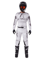 Alpinestars 2025 Racer Hollow Gear Set, White with black and grey graphics, full motocross racing outfit including jersey and pants, worn with black helmet, orange goggles, black gloves, and black boots, high-performance off-road apparel