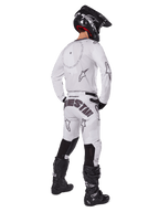 Alpinestars 2025 Racer Hollow Gear Set, White, rear view of a motocross rider wearing white jersey and pants with black branding, black helmet, and black boots, coordinated professional off-road racing outfit
