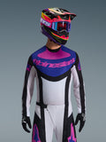 Alpinestars 2026 Techstar Knif Jersey, Motocross-Trikot, Schwarz, Hellgrau und Lila, pinkfarbenes Alpinestars-Logo auf der Brust, getragen mit passendem bunten Helm und Motocross-Hose, athletische Rennpassform mit lasergeschnittenen Perforationen zur Belüftung