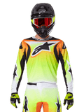 Alpinestars 2025 Fluid Wurx Jersey, Motocross Jersey, Neon Yellow Orange and White, worn with matching pants and black helmet with red goggles, complete MX gear ensemble on rider