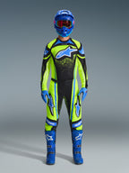 Motocross rider wearing complete racing gear, 2026 Techstar Nomur Jersey in yellow fluo and dark navy, matching motocross pants, blue helmet with red-tinted goggles, blue gloves, and blue boots, coordinated professional outfit for off-road racing