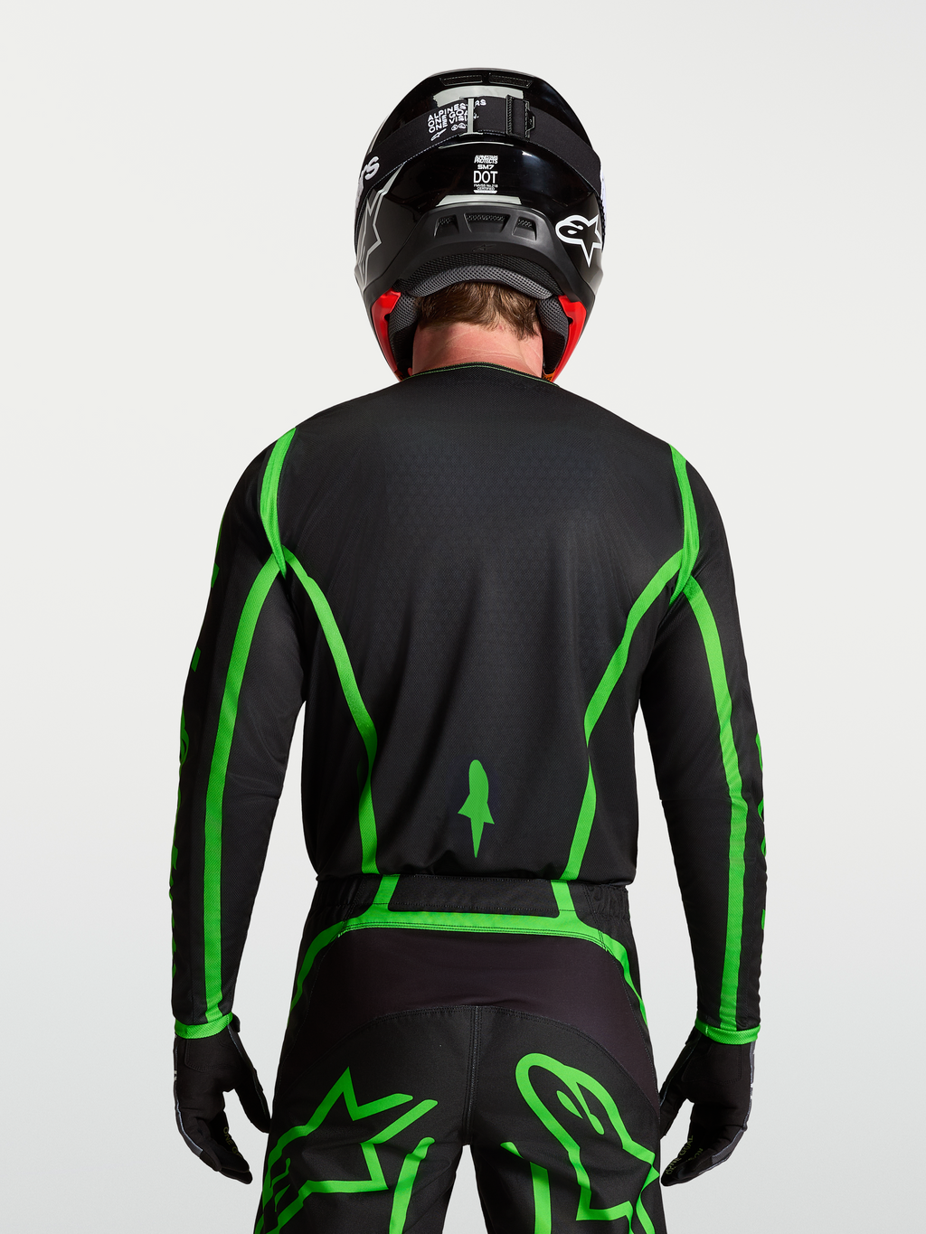 Alpinestars Fluid Apex V2 jersey, motocross, zwart en fluoriserend groen, achteraanzicht met verlengde achterzoom.