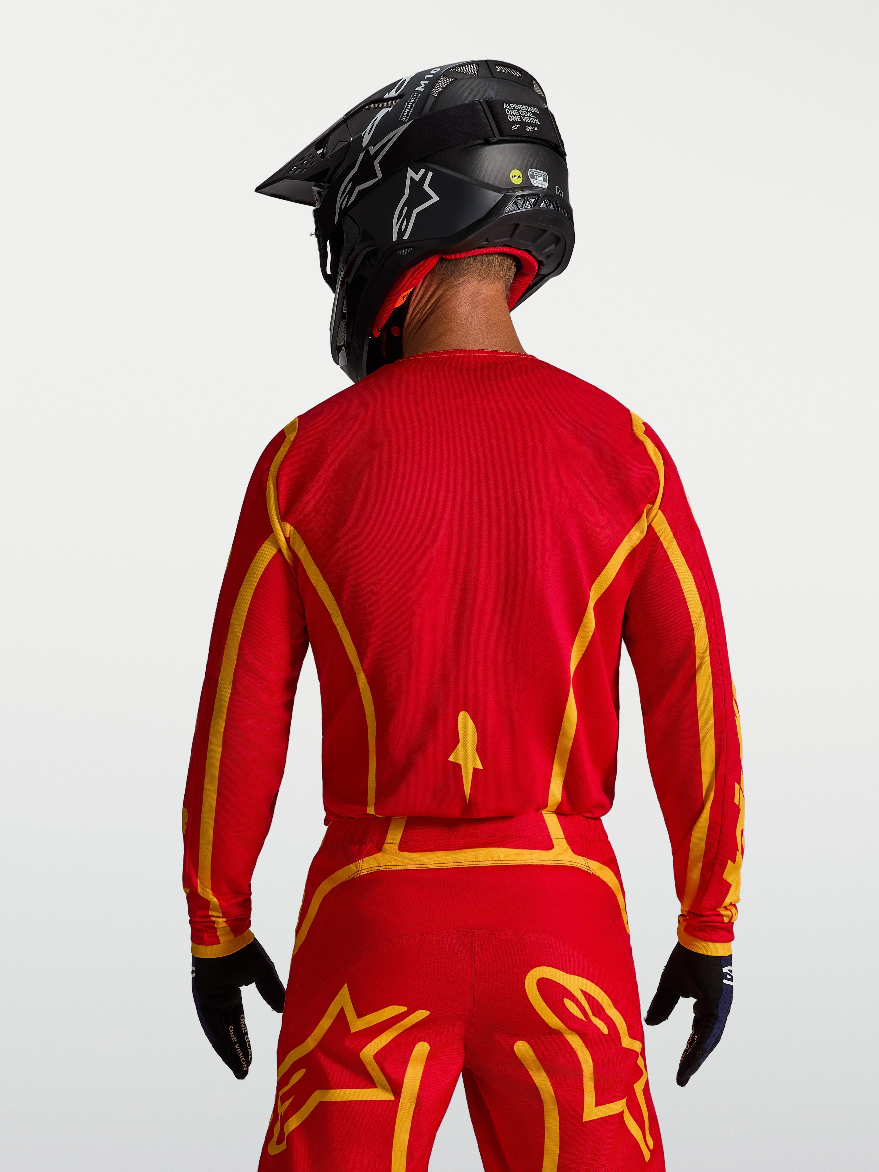 Alpinestars Fluid Apex V2 jersey, ademende heren motocross jersey in rood en goud, achteraanzicht met ergonomische snit.