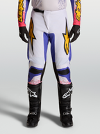 Alpinestars Fluid Drag heren motocrossbroek 2027 in licht lila en iris blauw met gouden accenten.