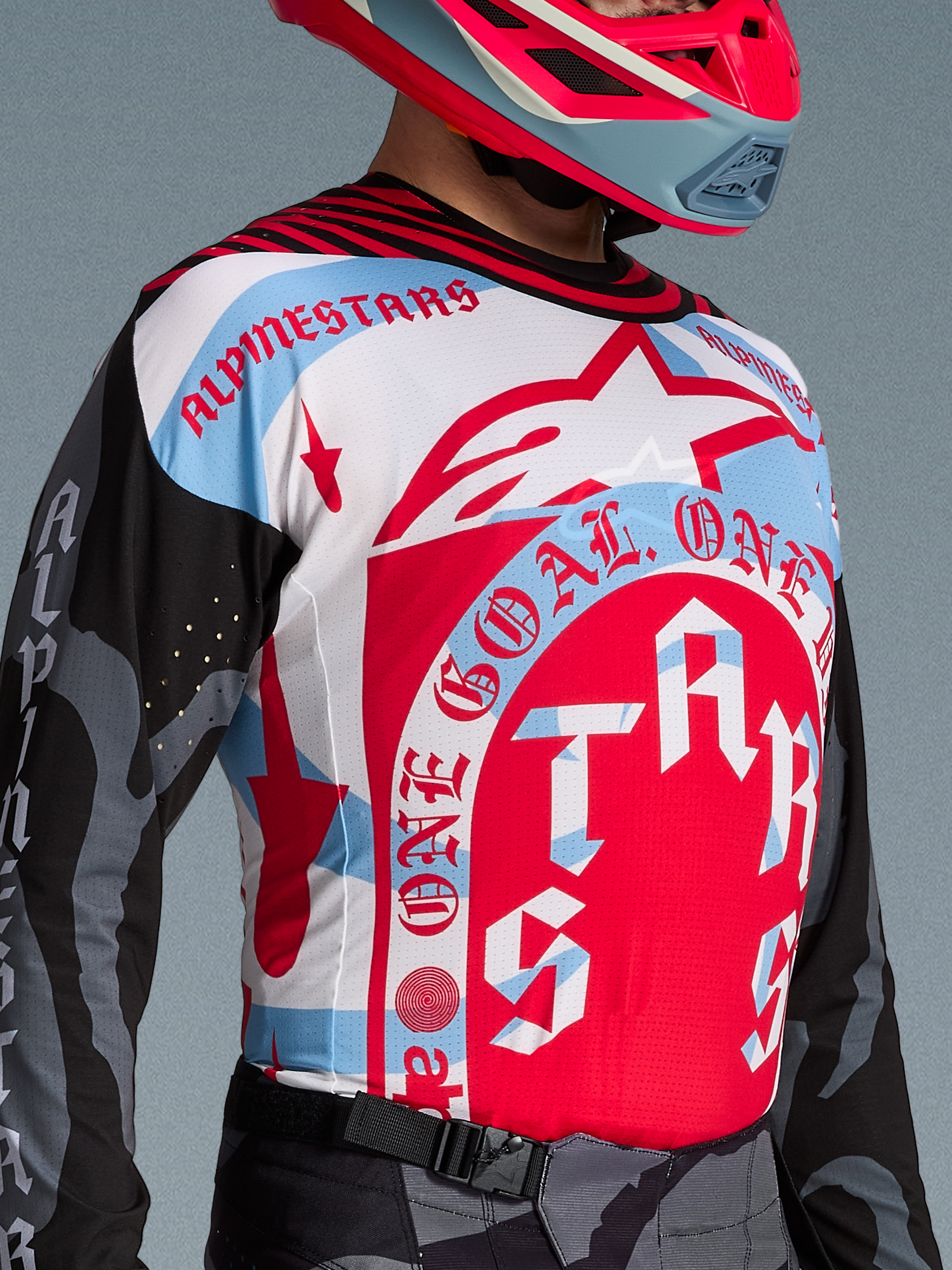 Maillot Alpinestars Techstar Beast Coast, rouge, blanc et bleu avec graphismes One Goal, textile aéré pour motocross.