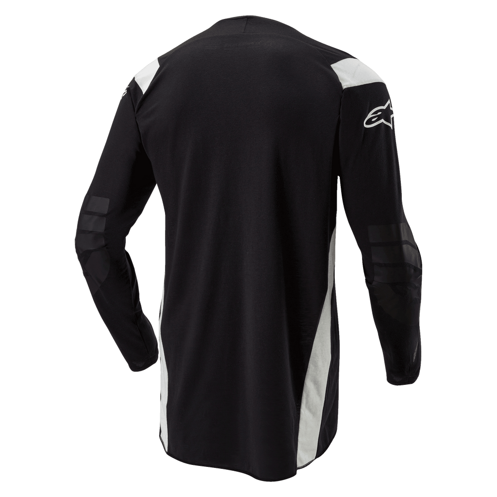 Maillot Alpinestars Techdura, maillot de motocross et d'enduro, noir avec accents blancs, vue arrière présentant un dos allongé, des coudes renforcés et le logo Alpinestars blanc sur la manche, vêtement de conduite tout-terrain durable