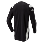 Maillot Alpinestars Techdura, maillot de motocross et d'enduro, noir avec accents blancs, vue arrière présentant un dos allongé, des coudes renforcés et le logo Alpinestars blanc sur la manche, vêtement de conduite tout-terrain durable