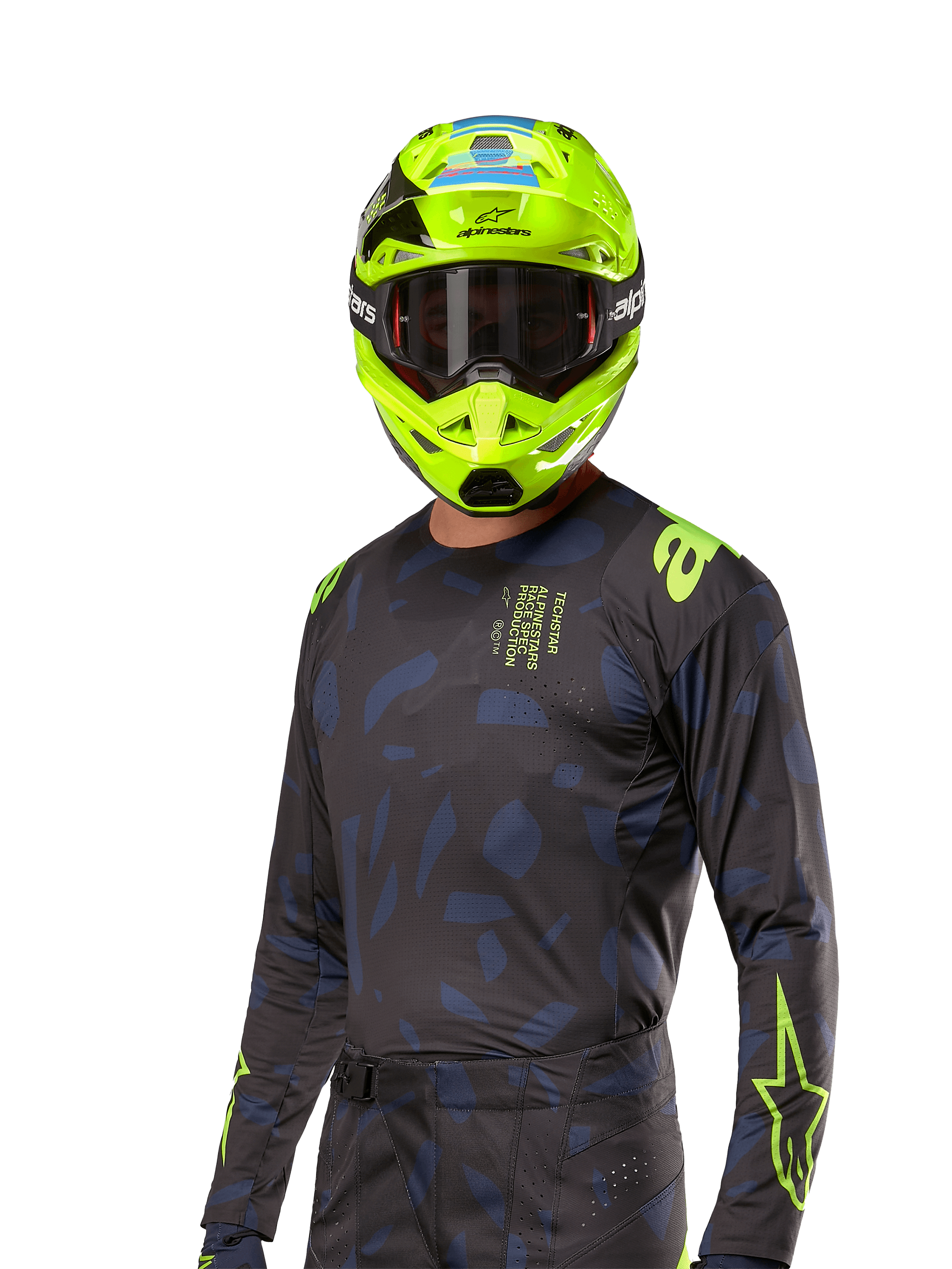 Alpinestars 2024 Techstar Rantera Jersey, maillot de motocross, noir et bleu marine avec motifs abstraits et accents jaune fluo, porté avec un casque jaune fluo assorti, design coupe performance pour la conduite tout-terrain
