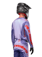 Alpinestars 2024 Techstar Ocuri Jersey, Motocross Jersey, Purple and Hot Orange, rear view on a rider wearing matching gear and a black helmet, featuring large orange Alpinestars lettering on the sleeves and lower back