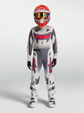Maillot et ensemble Supertech Swan Junior Alpinestars 2027, tenue de motocross grise et blanche aux accents rouges.