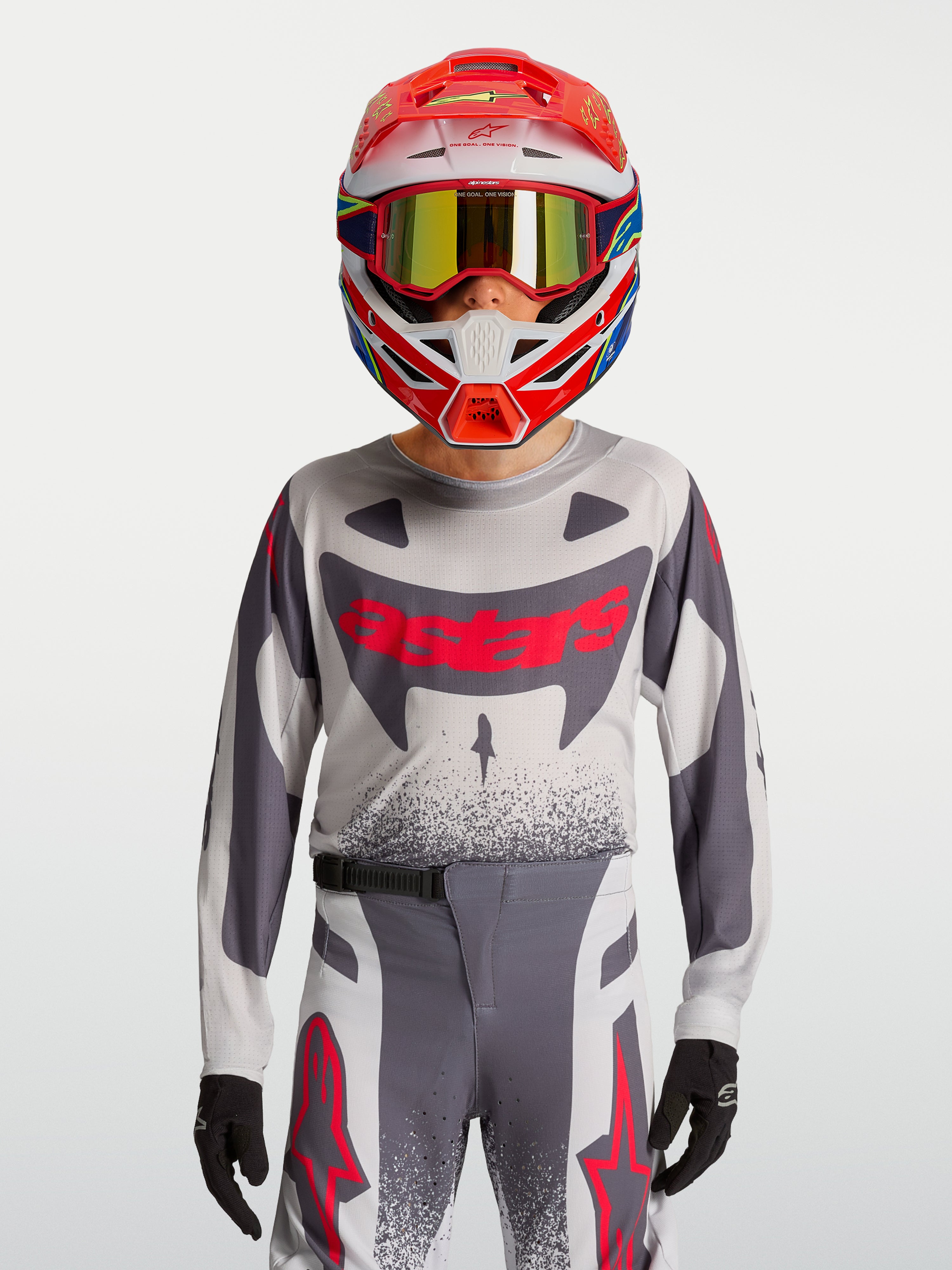 Alpinestars Supertech Swan Junior, tenue de motocross racing grise et rouge fluo en maille extensible respirante.