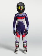 Alpinestars jeugd Supertech Dyna jersey en gear set 2027, paars-witte motocross-outfit met helm en motorlaarzen.