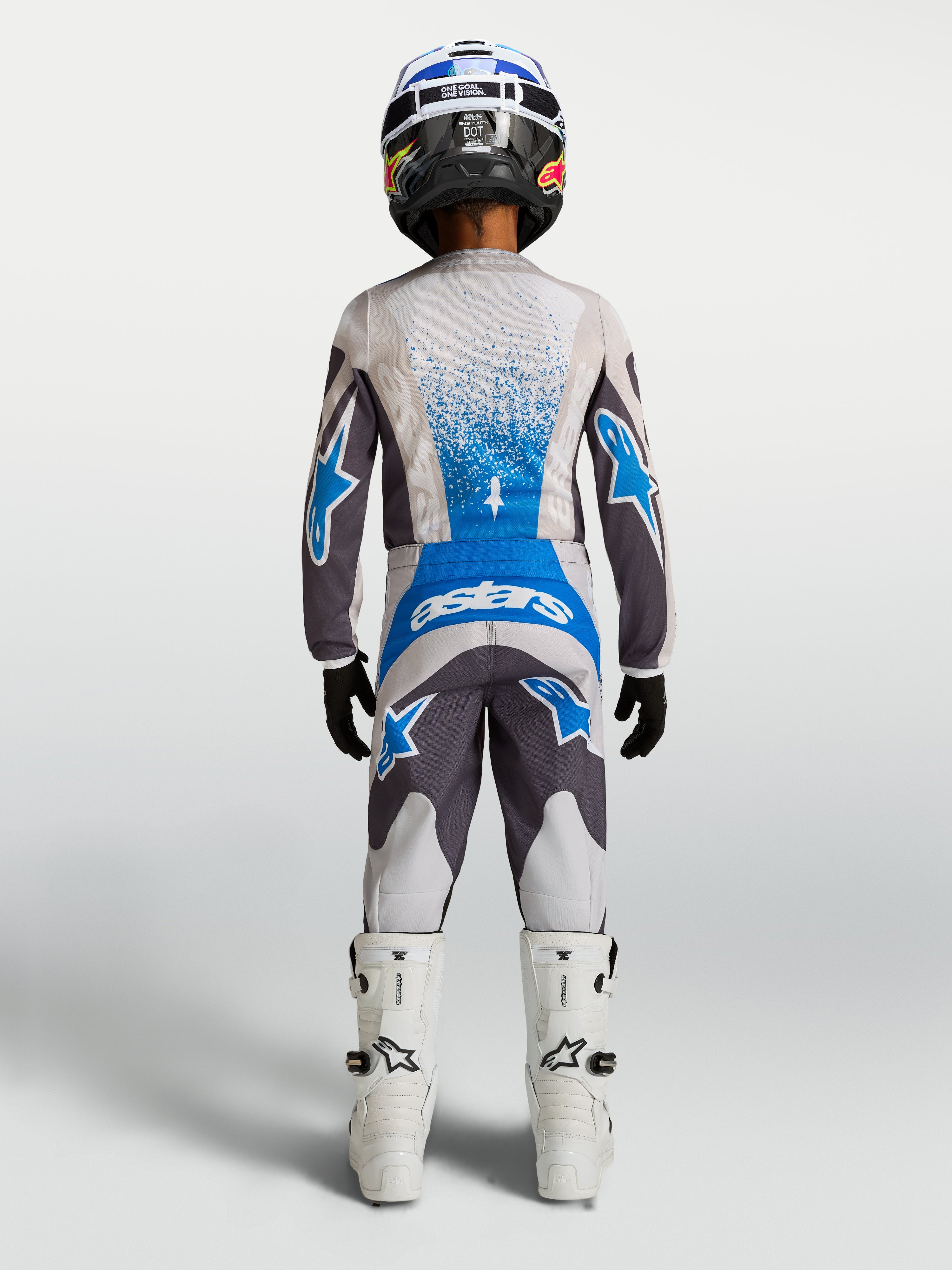 Alpinestars 2027 Jeugd Fluid Drag Gear Set, ademende motocrossuitrusting van textiel, grijs en blauw, achteraanzicht.
