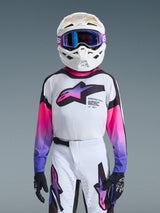 Alpinestars 2026 Youth Supertech Vista Jersey, Motocross Jersey, White with Pink and Purple gradient logos, worn with matching white pants and white helmet with purple goggles, pro-level athletic fit for off-road racing