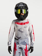 Maillot Fluid Lone Junior 2027 Alpinestars, maillot de motocross gris camouflage et rouge, textile respirant pour enfant.