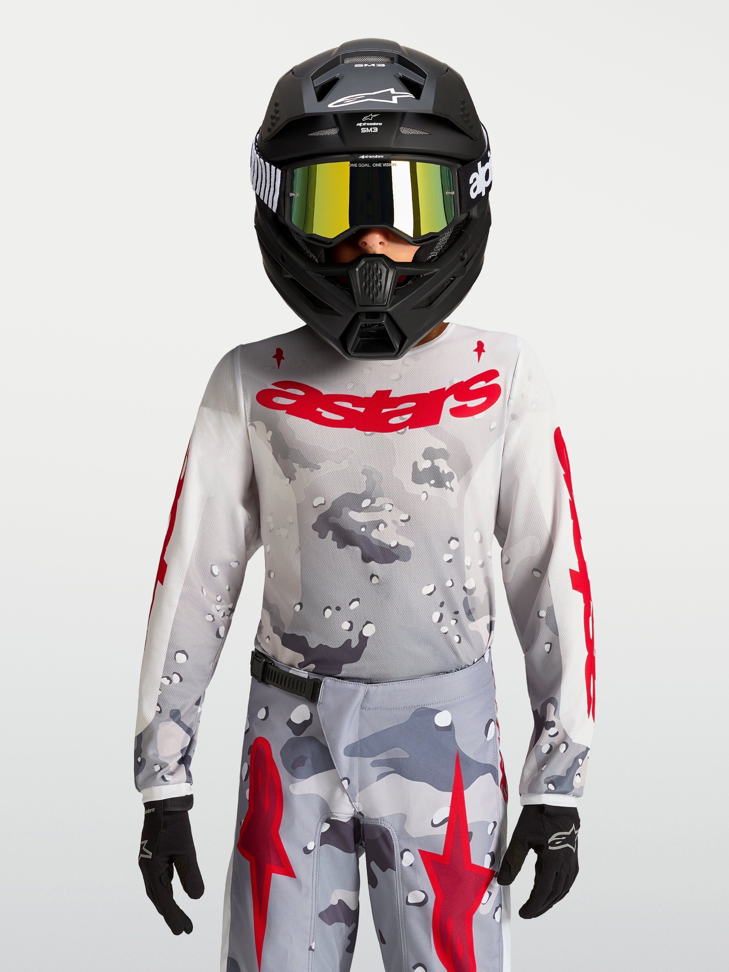 Maillot Fluid Lone Junior 2027 Alpinestars, maillot de motocross gris camouflage et rouge, textile respirant pour enfant.