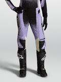 Stella Techstar Swan Pants, women's motocross racing pants in Light Violet and Black with cream leather accents, paired with black off-road boots.
