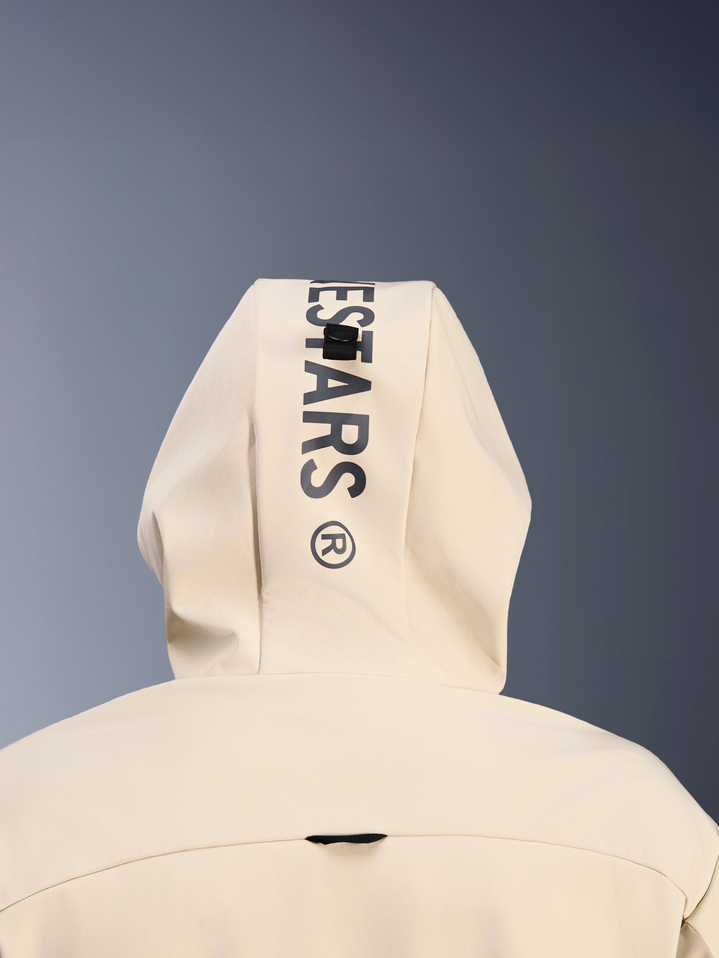 Alpinestars Radium Tech Hoodie in Mastic Aluminum, Nahaufnahme der Kapuze von hinten, vertikaler schwarzer Alpinestars-Schriftzug, Schlaufensystem zur Kapuzenbefestigung, Detail urbaner Motorradbekleidung