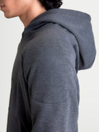 Alpinestars Ageless Hoodie, men's urban motorcycle riding hoodie in asphalt melange gray, close-up side profile view showing the knitted fabric construction and shoulder reinforcement details on a model