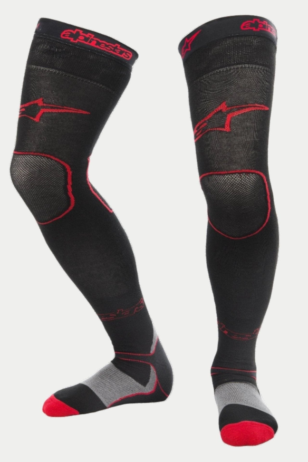 Alpinestars MX Long Tech Dicke Socken, Motocross-Fahrsocken, Schwarz und Rot, mit roten Alpinestars-Logos am Oberschenkel und am Bund, grauen Fersen- und roten Zehenakzenten, Oberschenkellänge mit speziellen Mesh-Zonen, technischer Baselayer für den Offroad-Rennsport