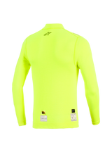 Haut à manches longues Alpinestars ZX Evo V3, vue arrière, jaune fluo, sous-couche jaune fluorescent résistante aux flammes avec logo étoile noir sur le haut du dos et étiquettes d'homologation à l'ourlet, vêtement technique de sport automobile