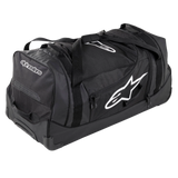 Alpinestars Komodo Travel Bag, large capacity gear bag, Black with white Alpinestars logos, featuring heavy-duty wheels, reinforced handles, and multiple zippered compartments for organized racing gear storage