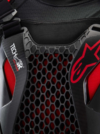 Alpinestars Tech-Air Off-Road System, off-road motorcycle airbag system close-up detail, Black and Red, featuring Nucleon CELL honeycomb chest protection, Tech-Air branding, and breathable stretch-mesh chassis