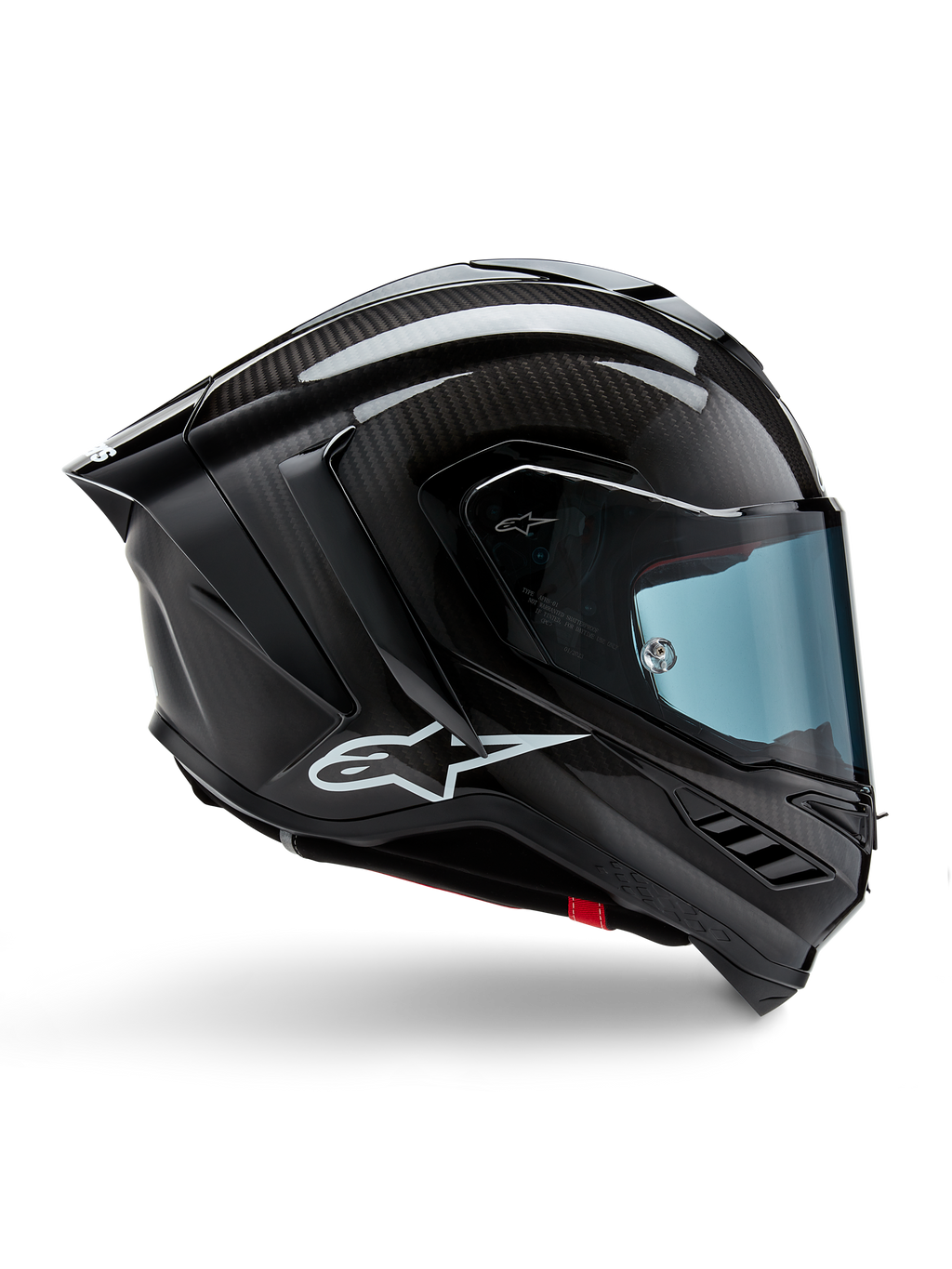 Alpinestars Supertech R10 Solid, casque de moto de course, carbone noir mat et brillant, construction en fibre de carbone, profil latéral, visière teintée bleue, design aérodynamique avec ailerons, logo blanc, protection haute performance de niveau MotoGP