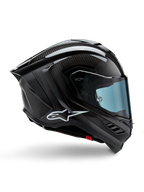 Alpinestars Supertech R10 Solid, casque de moto de course, carbone noir mat et brillant, construction en fibre de carbone, profil latéral, visière teintée bleue, design aérodynamique avec ailerons, logo blanc, protection haute performance de niveau MotoGP
