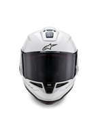 Casque Alpinestars Supertech R10 Solid, casque de course intégral, blanc brillant avec détails noirs, vue de face avec visière fumée foncée, système de ventilation aérodynamique et logo Astars noir