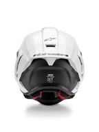 Casque Alpinestars Supertech R10 Solid, vue arrière, partie supérieure blanc brillant avec section inférieure noir mat, spoiler aérodynamique avec logo Alpinestars noir, texture en fibre de carbone visible et autocollants de certification de sécurité