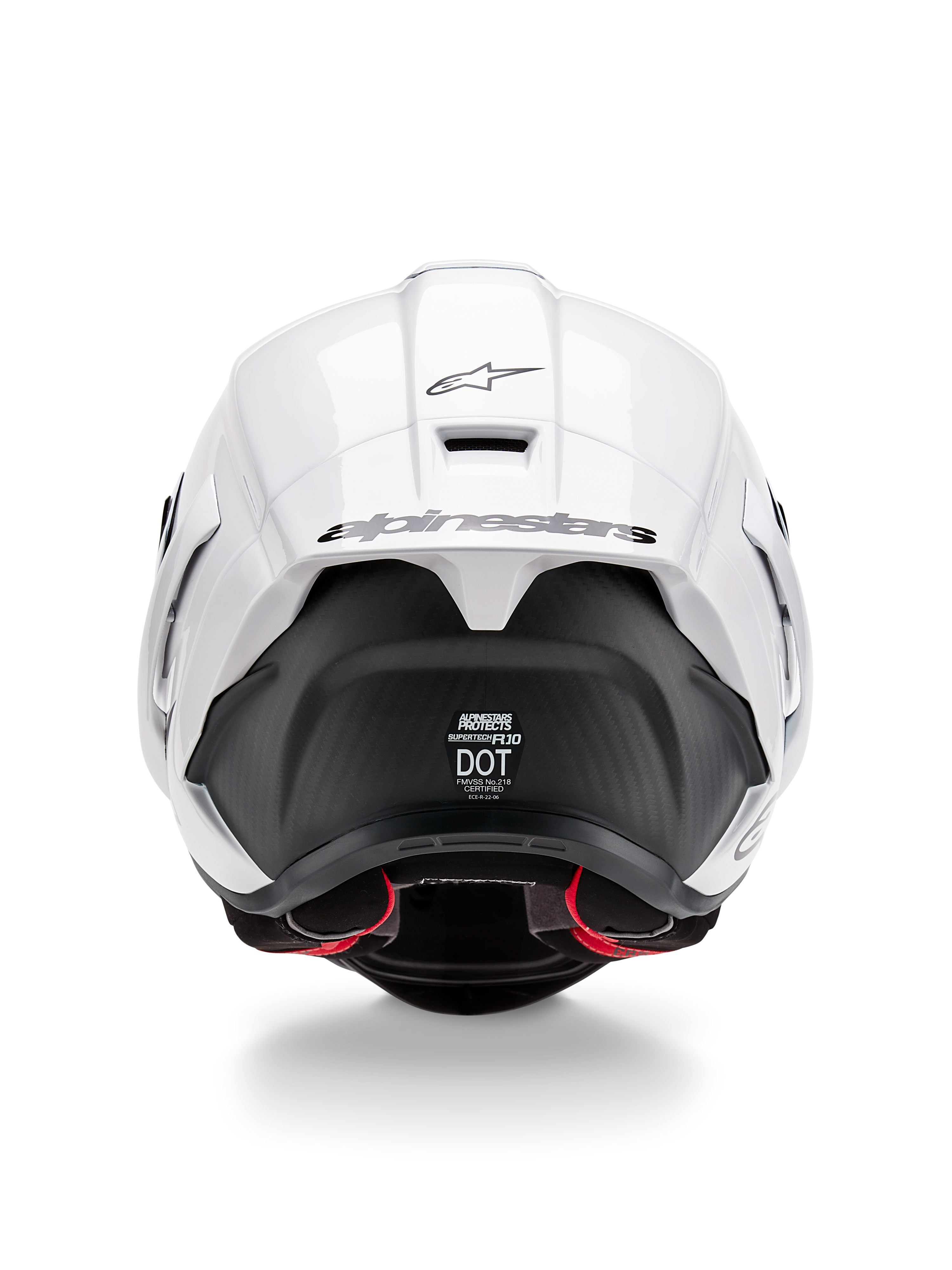 Casque Alpinestars Supertech R10 Solid, vue arrière, partie supérieure blanc brillant avec section inférieure noir mat, spoiler aérodynamique avec logo Alpinestars noir, texture en fibre de carbone visible et autocollants de certification de sécurité