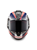 Casque Alpinestars Supertech R10 Team, casque moto intégral de course, carbone noir avec graphismes bleu mat et rouge fluo, vue de face avec écran fumé foncé, design aérodynamique avec aérations intégrées, équipement de course haute performance
