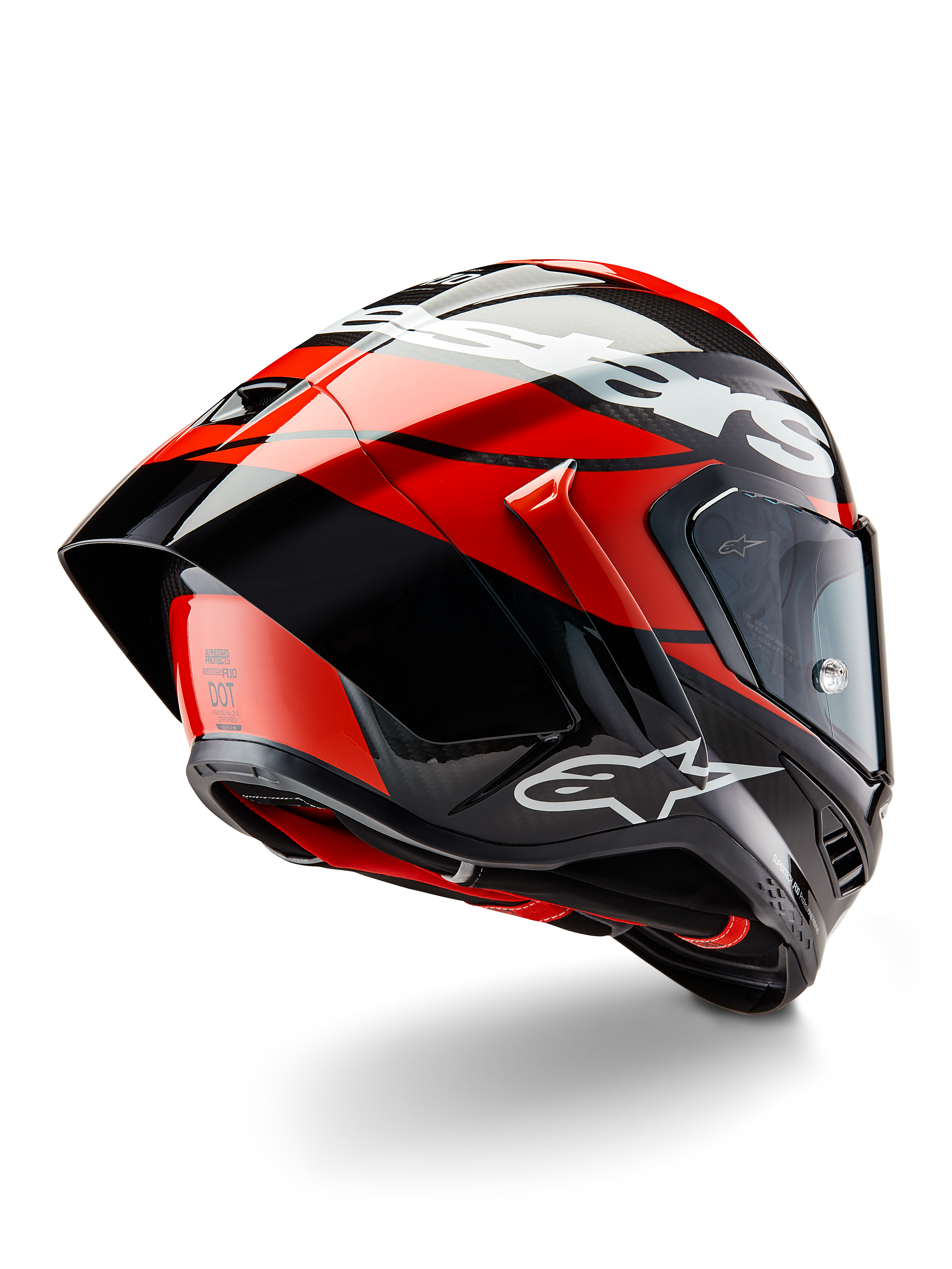 Casque Alpinestars Supertech R10 Element, Noir Carbone, Rouge Vif et Blanc Brillant, vue de trois-quarts arrière montrant le grand spoiler aérodynamique et la coque en fibre de carbone, avec logos Alpinestars distinctifs et certification DOT