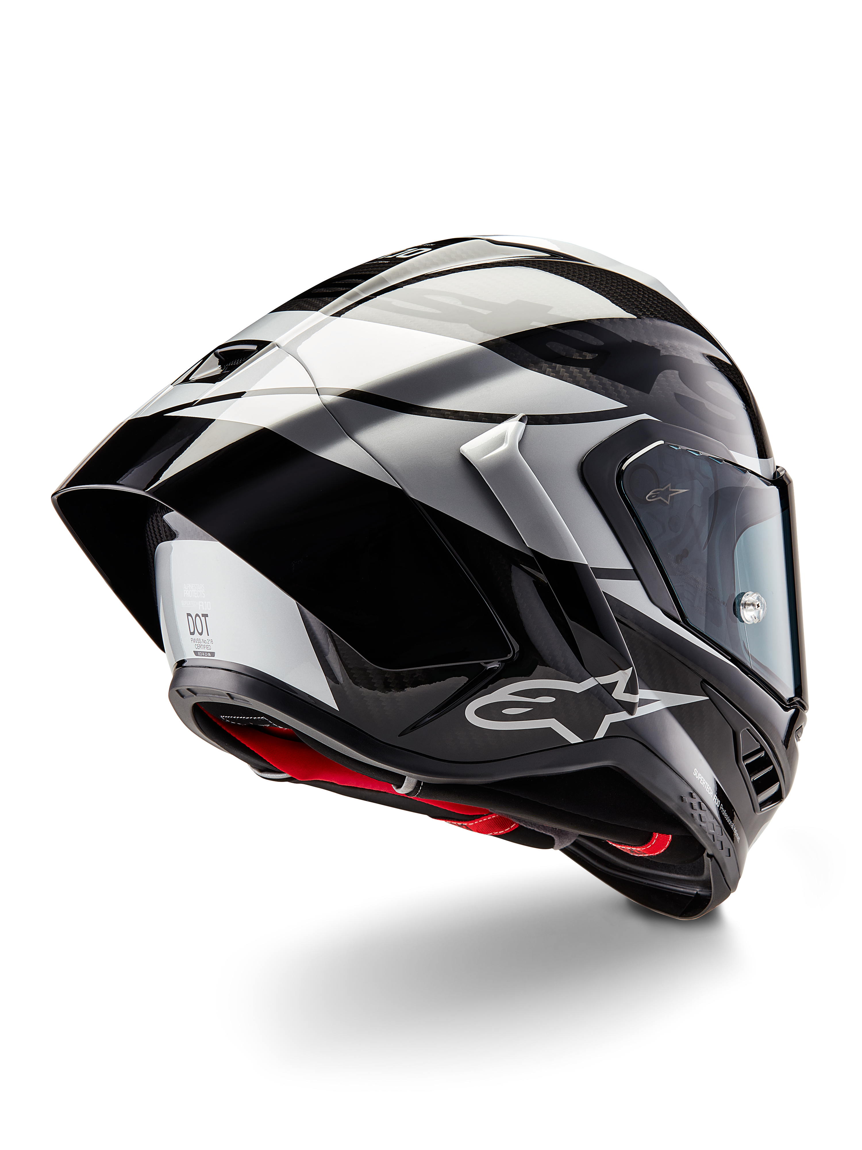 Casque Alpinestars Supertech R10 Element, Noir Carbone Argent Noir Brillant, vue de trois-quarts arrière montrant le profil aérodynamique de course, coque en fibre de carbone brillante avec motifs géométriques gris et noirs, logo Alpinestars et rembourrage intérieur rouge