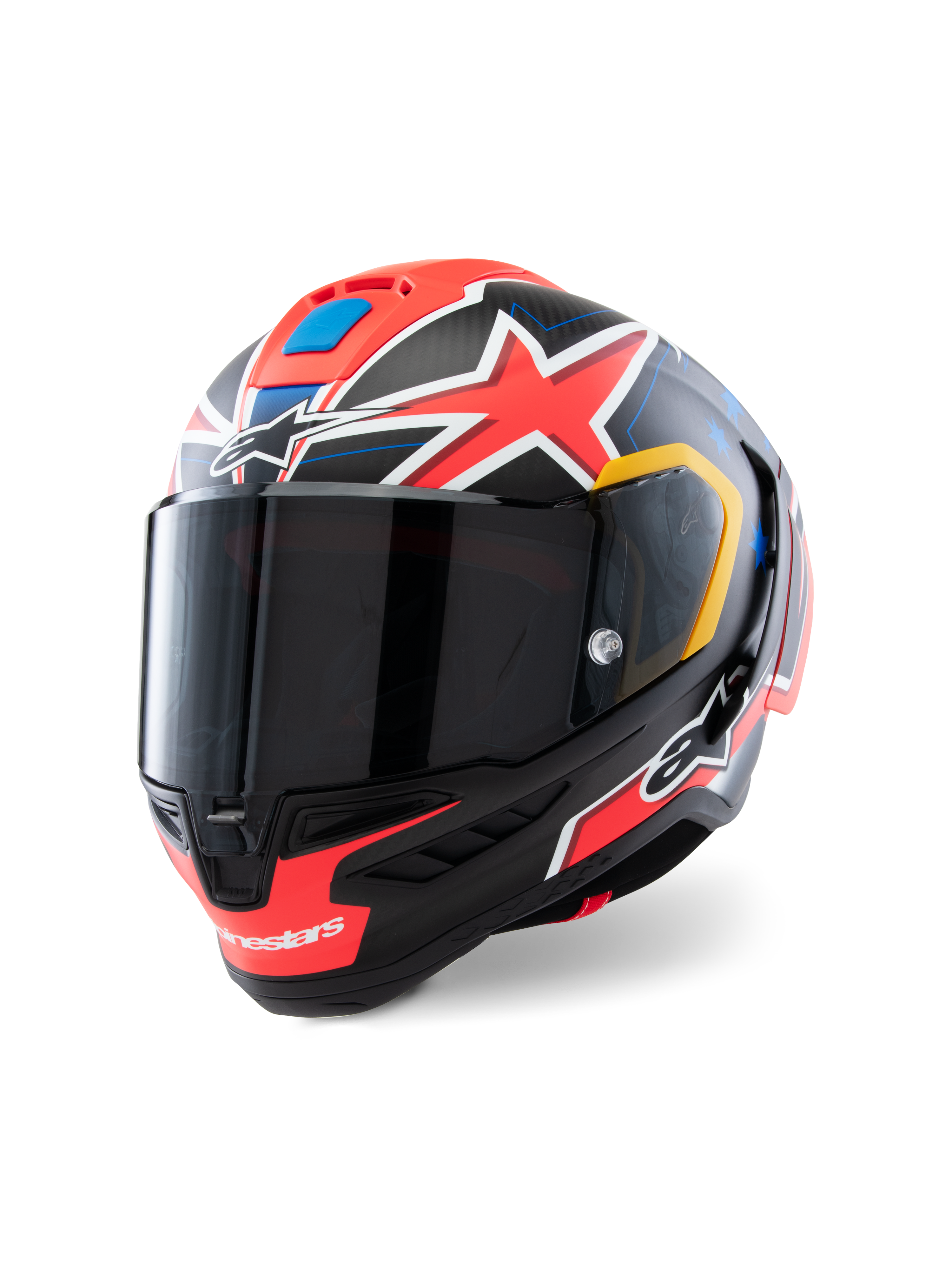 Casque Alpinestars Supertech R10 Miller Limited Edition, casque de course intégral, Carbone Rouge Mat avec étoiles rouges, accents bleus et jaunes, visière fumée foncée, coque en carbone aérodynamique pour la compétition moto professionnelle
