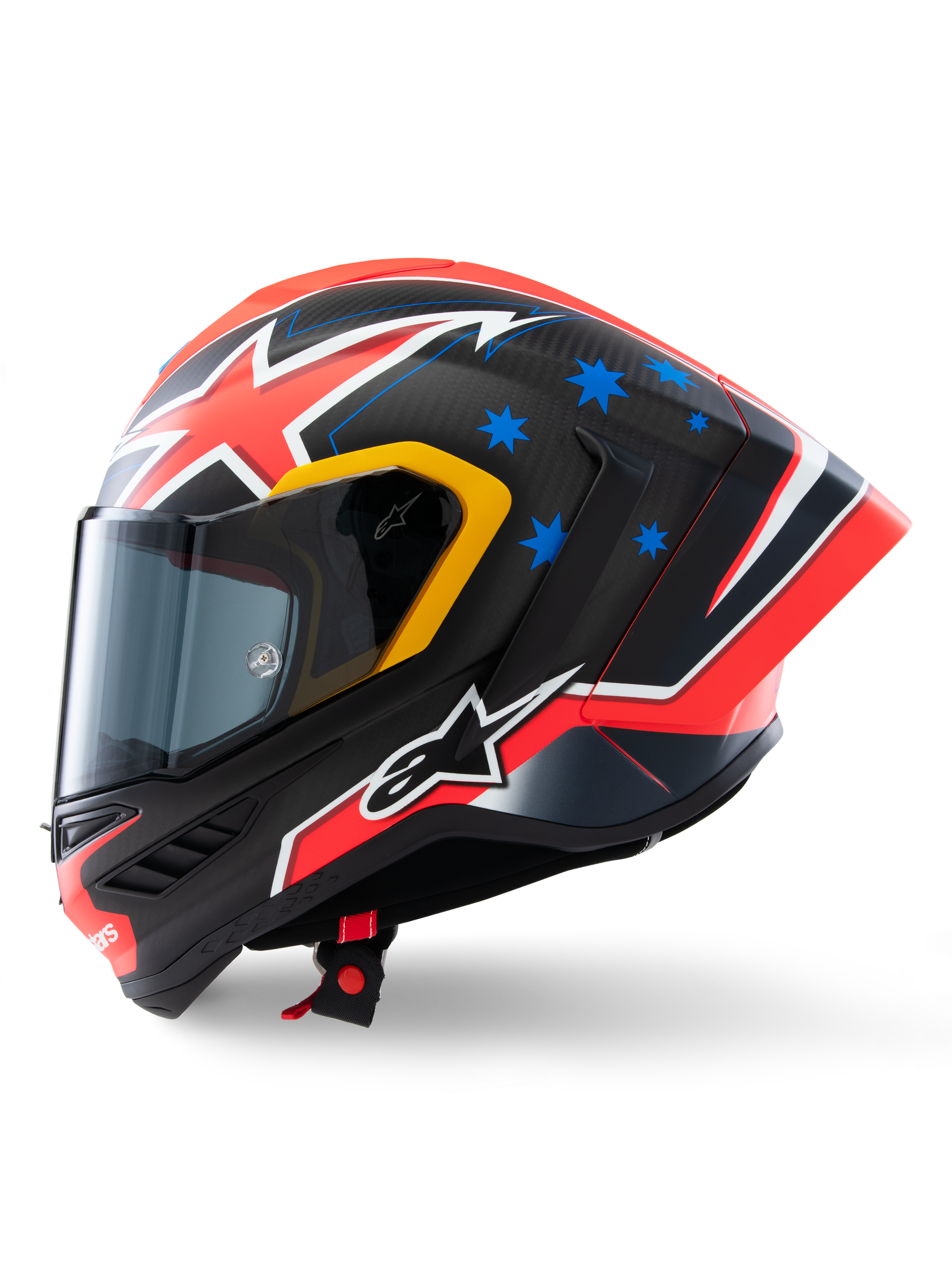 Casque Alpinestars Supertech R10 Miller Édition Limitée, profil latéral, finition Carbon Red Matt avec tissage de fibre de carbone visible, motifs d'éclairs rouges et blancs, étoiles bleues à l'arrière, détails jaunes autour de la visière et logo Alpinestars blanc, casque de moto de course haute performance