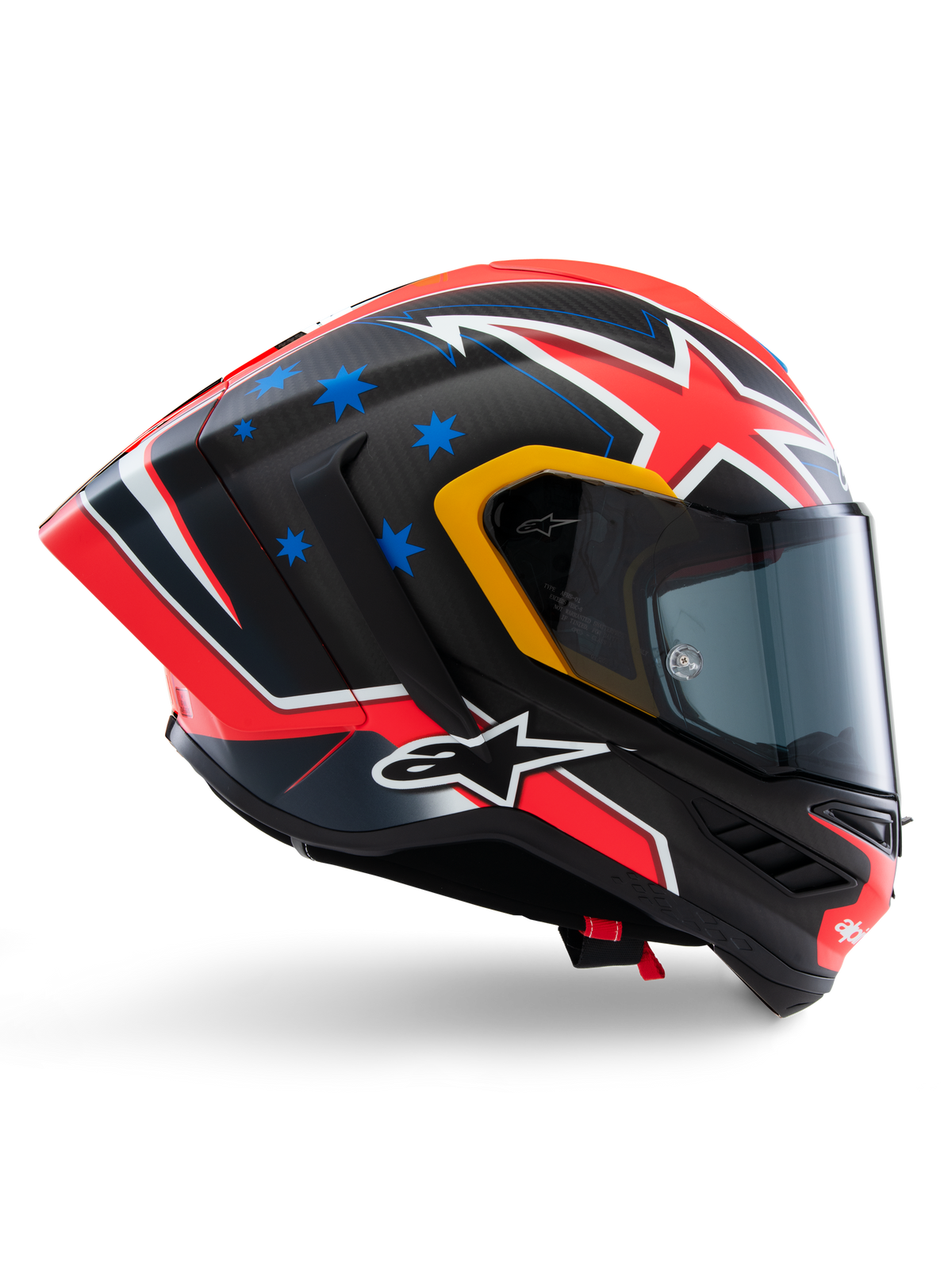 Alpinestars Supertech R10 Miller Limited Edition Helm, Integral-Rennhelm, mattes Carbon mit rot-weiß-blauen Grafiken, blaue Stern-Akzente und gelbe Visier-Details, aerodynamisches Profil mit dunkel getöntem Visier, Hochleistungs-Motorradschutzausrüstung