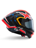 Casque Alpinestars Supertech R10 Miller Limited Edition, casque intégral de course, carbone mat avec graphismes rouges, blancs et bleus, motifs d'étoiles bleues et liseré de visière jaune, profil aérodynamique avec écran fumé foncé, équipement de sécurité moto haute performance