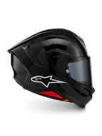 Alpinestars S-R7 Solid Helm, Integral-Motorradhelm, Schwarz glänzend, Profilansicht mit weißem A-Star-Logo, stromlinienförmige aerodynamische Außenschale mit integriertem Spoiler und roten Akzenten an der Unterseite, entwickelt für Rennsport- und Sport-Performance.