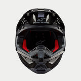 Casque Alpinestars Supertech M10 Solid, casque de motocross, carbone noir brillant, vue de face montrant la doublure intérieure rouge, la coque en fibre de carbone et le slogan « ONE GOAL. ONE VISION. » sur la visière