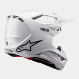 Alpinestars Supertech M10 Solid Helm, Motocross-Helm, Weiß glänzend, Dreiviertel-Rückansicht mit aerodynamischer Schale, schwarzem Stern-Logo und S-M10-Branding, mehrere Belüftungsöffnungen für den Offroad-Rennsport