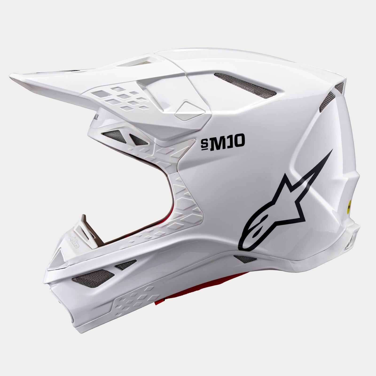 Alpinestars Supertech M10 Solid Helm, Motocross-Helm, Weiß Glänzend, Seitenansicht mit schwarzem Astars-Logo und S-M10-Branding, mit mehreren Mesh-Belüftungsöffnungen und einem schlanken aerodynamischen Design.