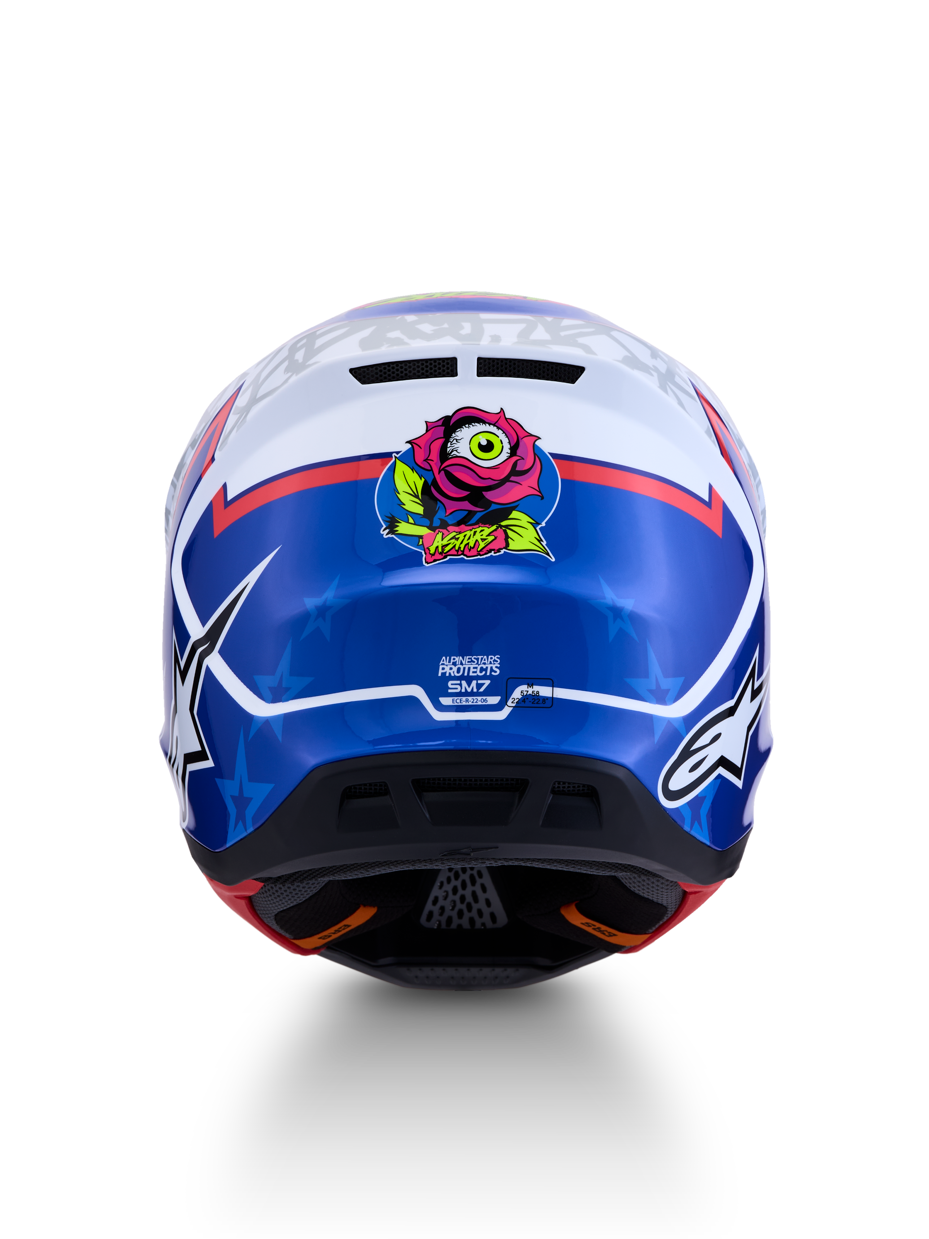 Alpinestars S-M7 Blaster Helm ECE06, blauwe en witte motocrosshelm, achteraanzicht met unieke roos- en oog-grafiek, ECE 22.06 gecertificeerd, aerodynamisch ontwerp voor off-road racing en motorcross.