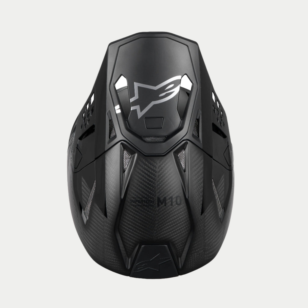 Alpinestars Supertech M10 Fame ECE 22.06 Helmet, Motocross Helmet, Black Carbon Matte and Glossy, top-down view highlighting the carbon fiber weave, aerodynamic visor with silver Alpinestars logo, and multiple ventilation ports for off-road racing.