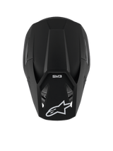 Alpinestars S-M3 Solid helm, motorcrosshelm, Black Matt, bovenaanzicht dat de matte textuur en aerodynamische schaal toont, voorzien van wit Alpinestars sterlogo op de klep en SM3-branding, premium hoofdbescherming voor off-road racing