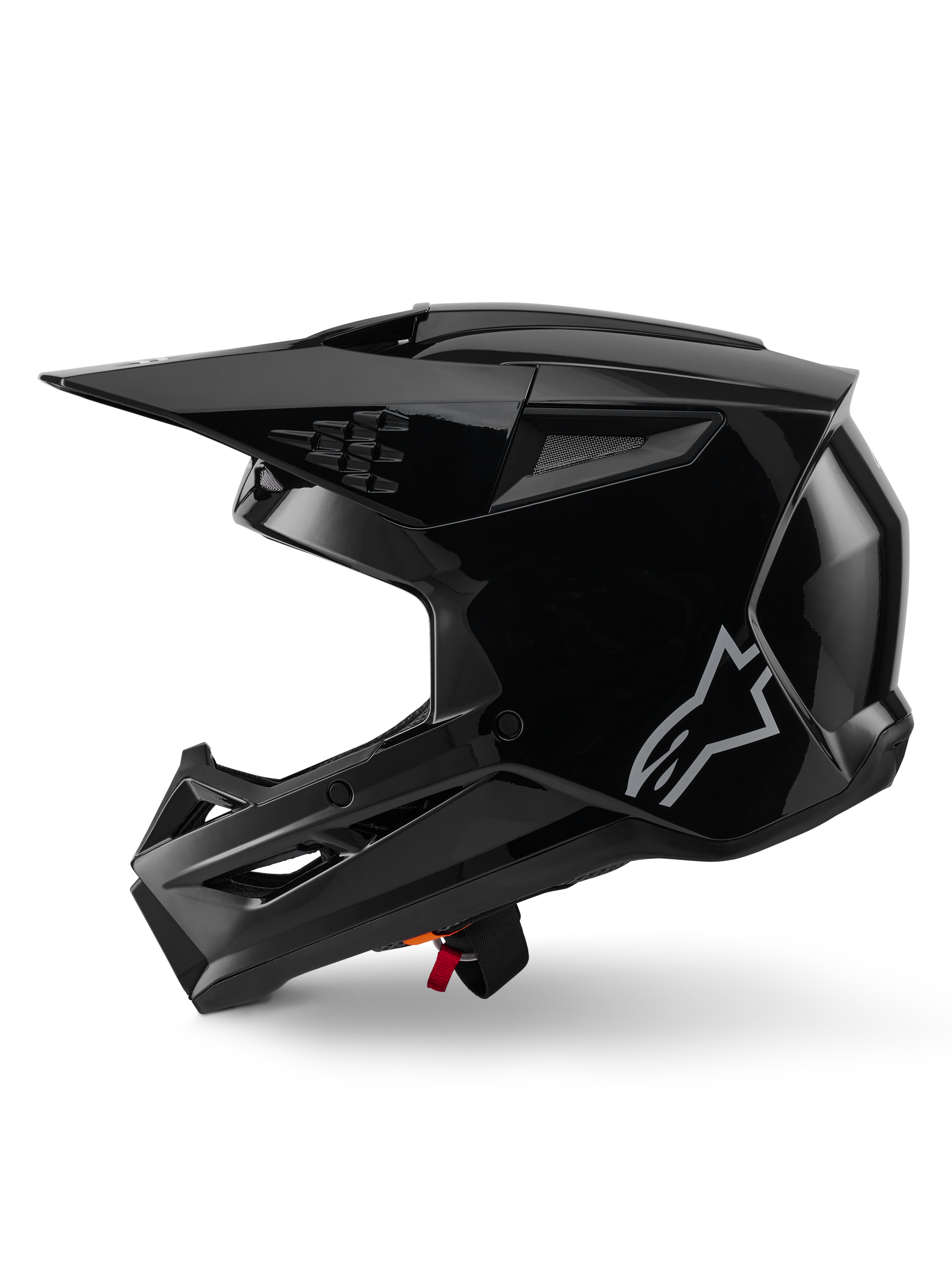 Alpinestars S-M3 Solid helm, motorcrosshelm, zwart glanzend, zijaanzicht, met een zilveren Alpinestars-logo, aerodynamisch vizier en meerdere ventilatieopeningen voor off-road racing